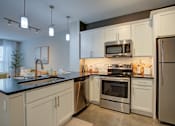 Thumbnail 2 of 35 - Modern kitchen at Vista at the Heights Apartments in Lansing, MI