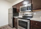 Thumbnail 2 of 18 - Kitchen at Whispering Pines Apartments in Holland, Michigan