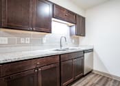 Thumbnail 3 of 18 - Kitchen at Whispering Pines Apartments in Holland, Michigan