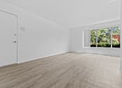 Thumbnail 9 of 38 - a bedroom with hardwood floors and white walls