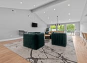 Thumbnail 15 of 44 - a living room with two green couches and a rug