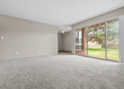 Thumbnail 34 of 35 - a spacious living room with a sliding glass door to the backyard