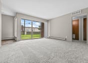Thumbnail 35 of 35 - a living room with a large window and a door leading to a yard