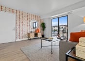 Thumbnail 8 of 21 - a living room with a large window and a door to a balcony  at Park On Canal Apartments, Clinton Twp, MI