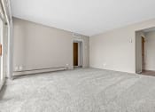 Thumbnail 32 of 35 - a bedroom with gray walls and a carpeted floor
