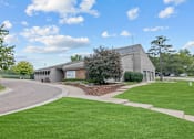 Thumbnail 45 of 50 - a large building with a grassy area in front of it