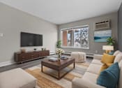 Thumbnail 4 of 12 - A living room with a brown coffee table and a white couch.