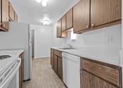 Thumbnail 25 of 35 - a kitchen with wooden cabinets and white appliances