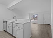 Thumbnail 6 of 41 - a kitchen with white cabinets and a large counter top