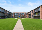 Thumbnail 34 of 46 - a grassy area with a walkway in at Lafayette Park Place, Detroit, MI, Detroit, MI, 48207
