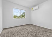 Thumbnail 19 of 38 - a bedroom with a window and carpet