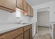 Thumbnail 19 of 35 - a kitchen with wooden cabinets and white appliances