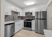 Thumbnail 9 of 116 - A kitchen with stainless steel appliances and white cabinets.