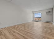 Thumbnail 6 of 73 - an empty living room with wood flooring and a window