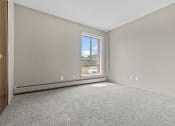 Thumbnail 30 of 35 - a bedroom with a large window and carpet