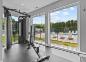 Thumbnail 6 of 44 - a home gym with windows and a view of a pool