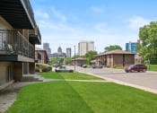 Thumbnail 39 of 46 - a lawn in front of a building with a view of the city in the background at Lafayette Park Place, Detroit, MI, Michigan