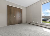 Thumbnail 26 of 35 - a bedroom with two doors and a large window