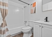 Thumbnail 13 of 21 - a bathroom with a sink toilet and a tub  at Park On Canal Apartments, Clinton Twp, 48038