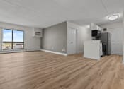Thumbnail 29 of 73 - an empty living room with wood flooring and a window