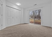 Thumbnail 15 of 41 - an empty living room with a window and a door to a yard