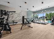 Thumbnail 28 of 30 - A gym with a variety of equipment including treadmills, weights, and exercise machines at Park On Canal Apartments - Clinton Twp, MI Apartments, Clinton Twp, Michigan