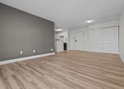 Thumbnail 32 of 73 - the living room and kitchen of an apartment with wood flooring