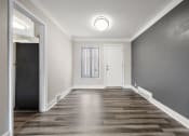 Thumbnail 10 of 32 - a empty room with a door and a window and a hallway