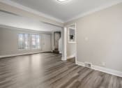 Thumbnail 9 of 32 - the living room and dining room of an empty home with wood flooring