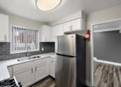 Thumbnail 2 of 32 - a kitchen with white cabinets and a stainless steel refrigerator