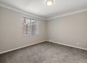 Thumbnail 19 of 32 - an empty room with carpet and a window