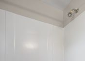 Thumbnail 16 of 32 - a white bathroom with a white tub and a sink