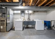 Thumbnail 21 of 32 - a room with two washing machines and two refrigerators in it