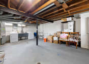 Thumbnail 22 of 32 - a room with a lot of boxes and a kitchen in it