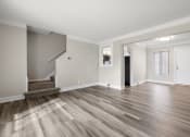 Thumbnail 8 of 32 - an empty living room with wood flooring and a staircase