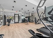 Thumbnail 21 of 30 - A gym with a variety of equipment including treadmills and weights at Park On Canal Apartments - Clinton Twp, MI Apartments, Clinton Twp, Michigan