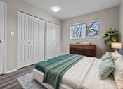 Thumbnail 6 of 12 - A bedroom with a bed, a dresser, and a window.