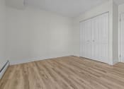 Thumbnail 9 of 73 - the living room of an apartment with white walls and wood flooring