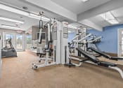 Thumbnail 20 of 35 - a fitness center with cardio equipment and exercise machines