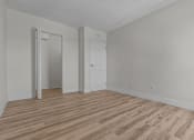 Thumbnail 8 of 73 - an empty living room with wood flooring and white walls