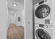 Thumbnail 24 of 38 - a white washer and dryer in a white laundry room with a white door