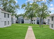 Thumbnail 47 of 50 - a grassy area with trees and houses in the background