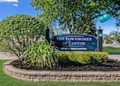 Thumbnail 14 of 14 - A sign that says "The Townhomes of Canton Newly Renovated" is displayed in front of a landscaped area.