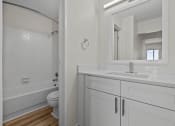 Thumbnail 7 of 73 - a bathroom with a sink and a toilet and a mirror
