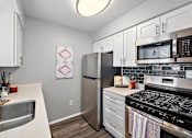 Thumbnail 4 of 45 - a kitchen with stainless steel appliances and a stainless steel microwave