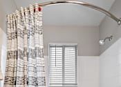 Thumbnail 11 of 45 - a bathroom with a bath tub and a shower curtain