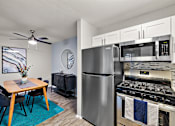 Thumbnail 1 of 28 - A modern kitchen with a dining table and chairs.