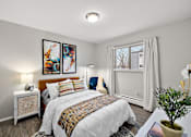 Thumbnail 5 of 28 - A bedroom with a large bed and two framed pictures on the wall.