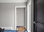 Thumbnail 11 of 28 - A black door with a mat that says "HELLO" on it.