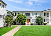 Thumbnail 29 of 33 - the view of an apartment building with a green lawn and a orange door
